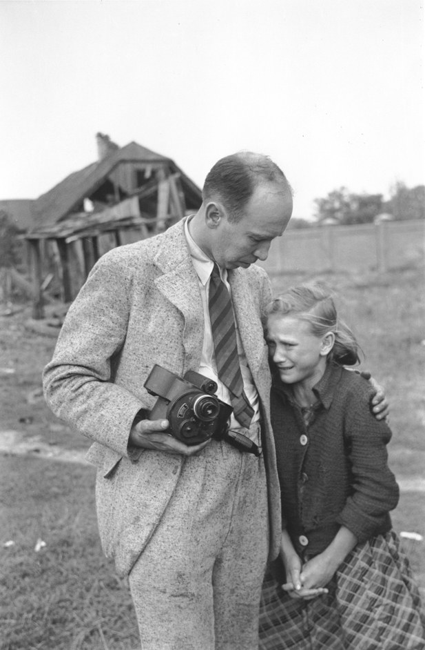 Julien Bryan comforts ten-year-old Kazimiera Mika in a field in Warsaw, 13 September 1939