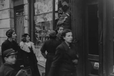 Women and a boy outside a shop doorway, Kraków, 1936