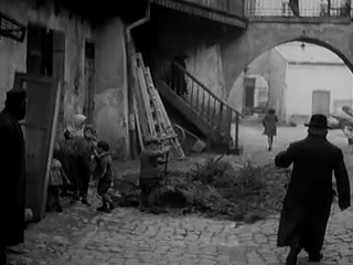 Wider Film 3000 view of the Józefa 12 courtyard, with the arch, stairs, and brush pile, Kraków, 1936