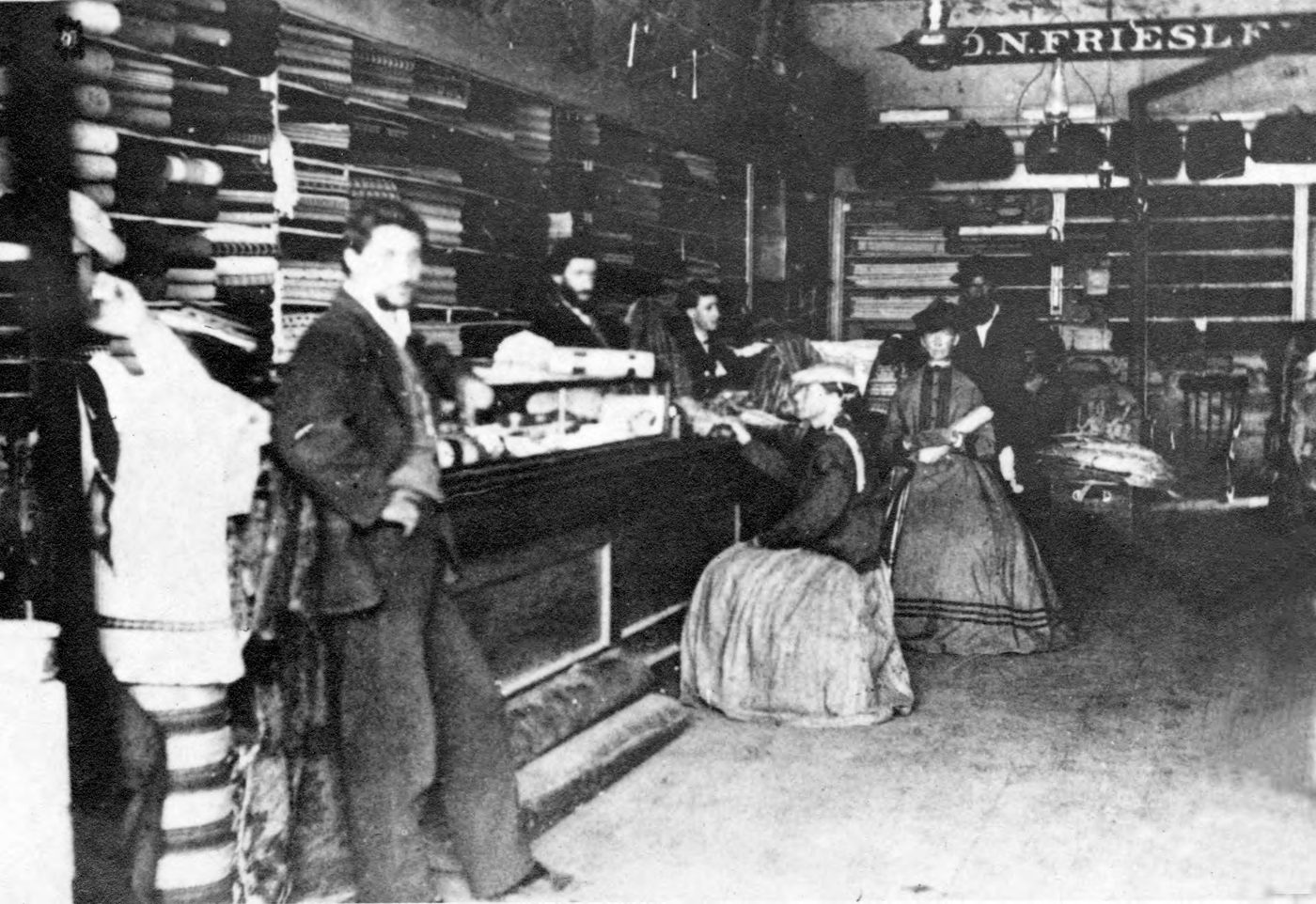 Interior of the D. N. Friesleben store in Oroville, California, about 1880, with clerks behind the counter and the D. N. Friesleben sign overhead