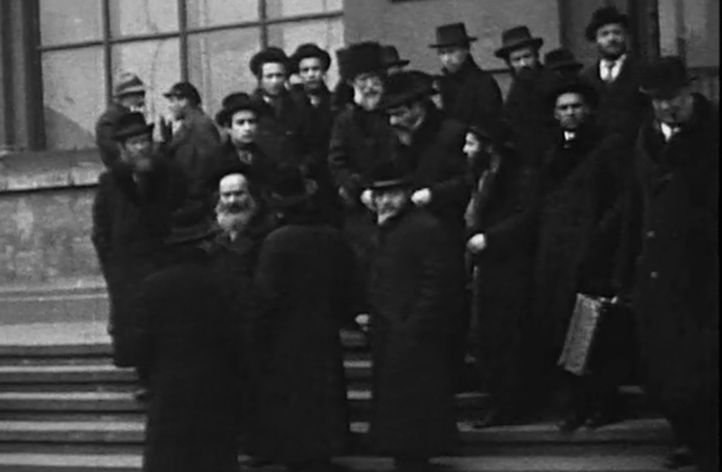 Chasidim in long coats and hats descending stone steps in Lwów, 1929