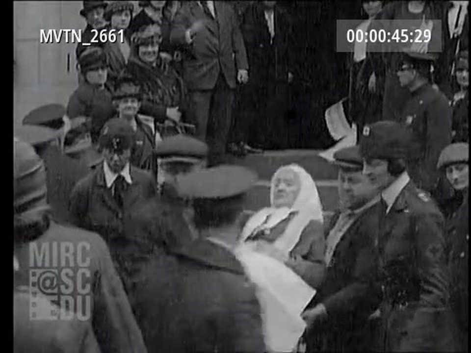 An older resident carried down from the steps of the home