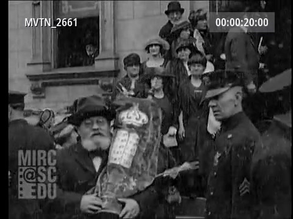 A man carries a sefer Torah out of the Daughters of Jacob home