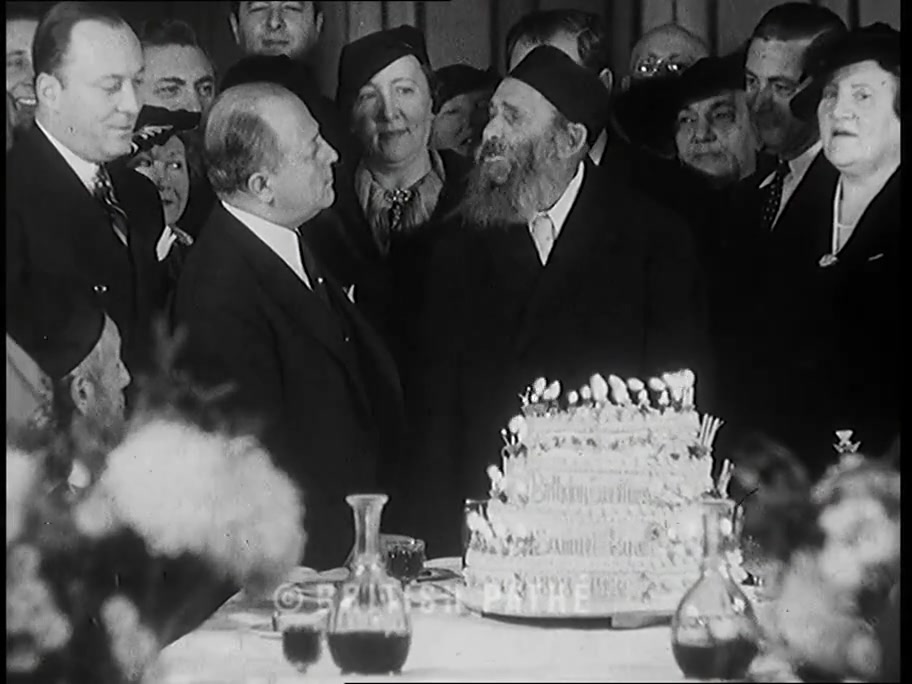 British Pathé close shot of Samuel Baron’s face and beard beside the birthday cake