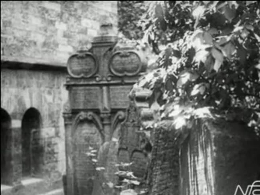 1926 film frame: ornate cemetery markers after the Oppenheimer title card; not Oppenheimer’s grave