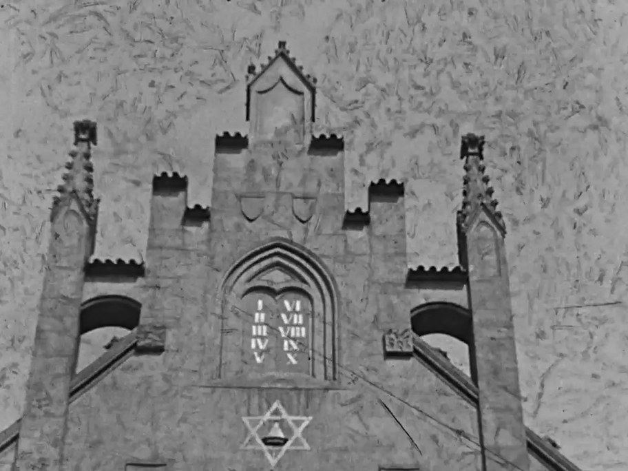 1934 film frame: Maisel Synagogue gable with the Ten Commandments and a Star of David