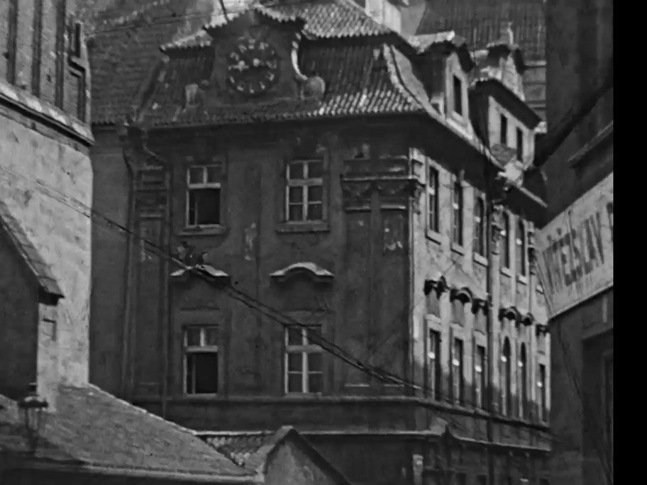 1934 film frame: Jewish Town Hall from the street, Hebrew clock on the gable