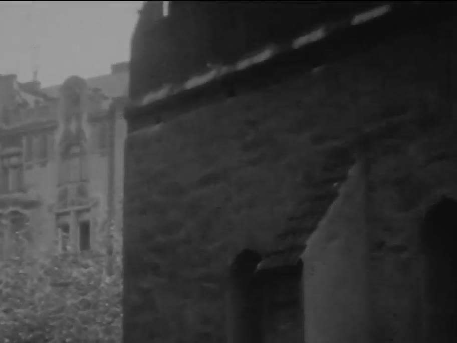 1936 film frame: Old-New Synagogue stepped gable from the street