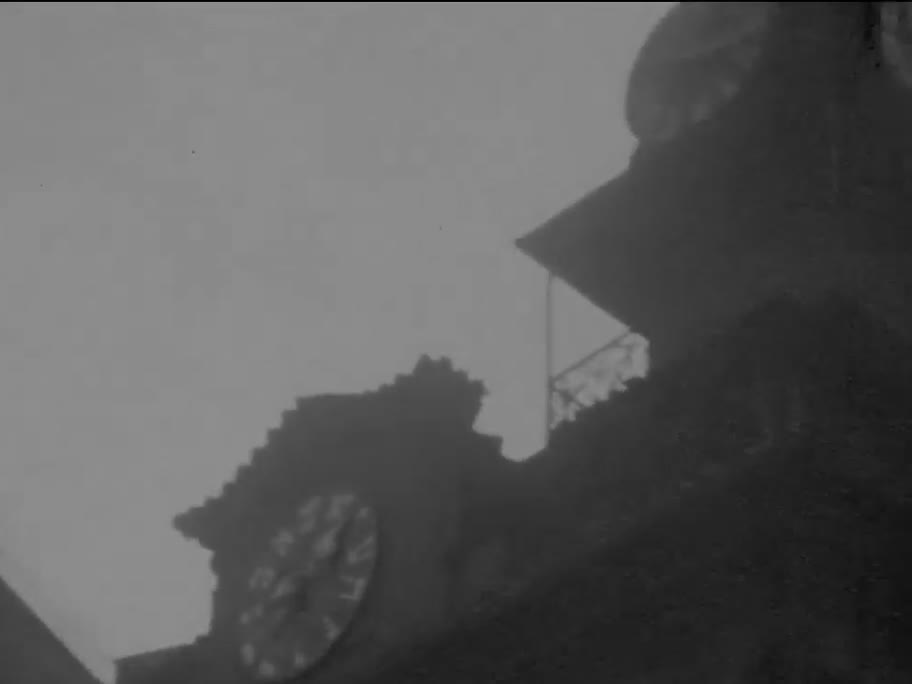 1936 film frame: Hebrew clock on the Jewish Town Hall gable