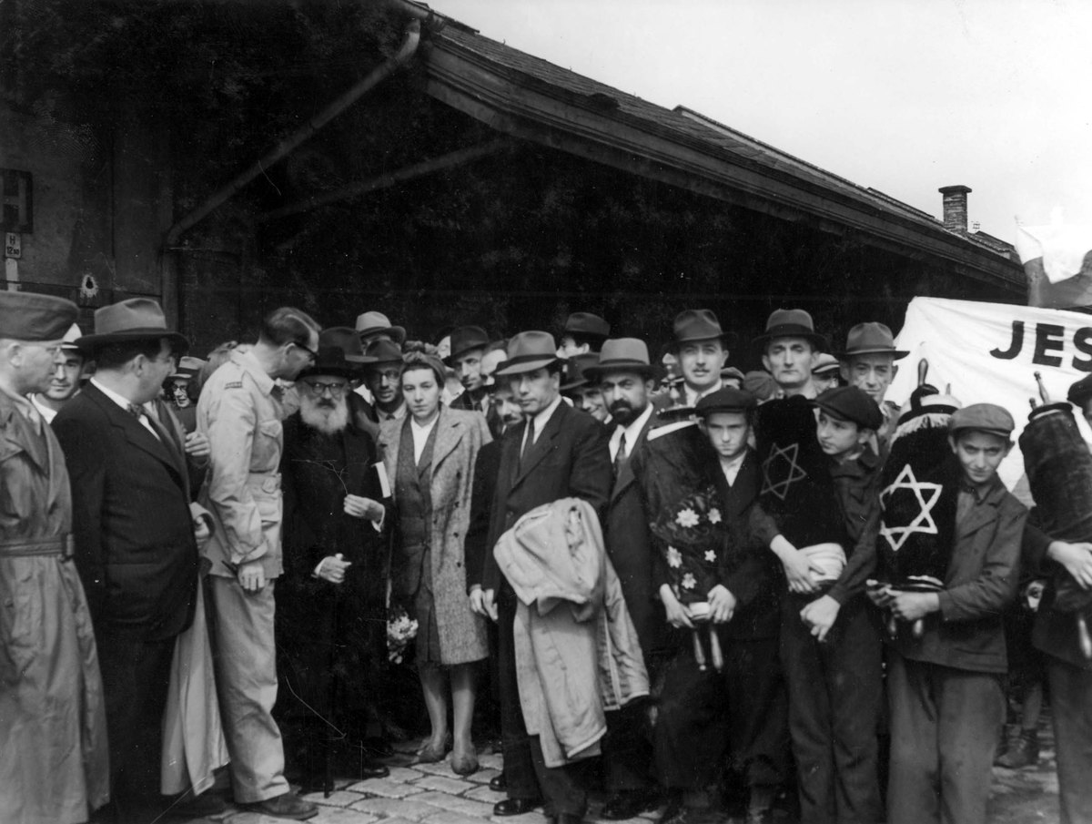Yad Vashem FA160/35: Rabbi Herzog with orphans holding Torah scrolls from Poland; Rebbetzin Sternbuch nearby