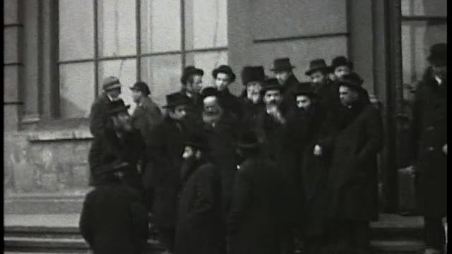 Chasidim gathered on stone steps in Lwów, 1929