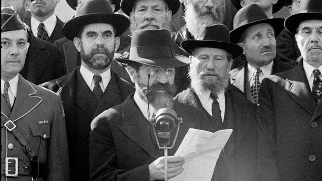 Rabbi Wolf Gold reads into a microphone on the Capitol steps, October 6, 1943